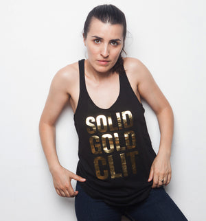 Black racerback tank top with the text SOLID GOLD CLIT in gold foil worn by artist Sophia Wallace