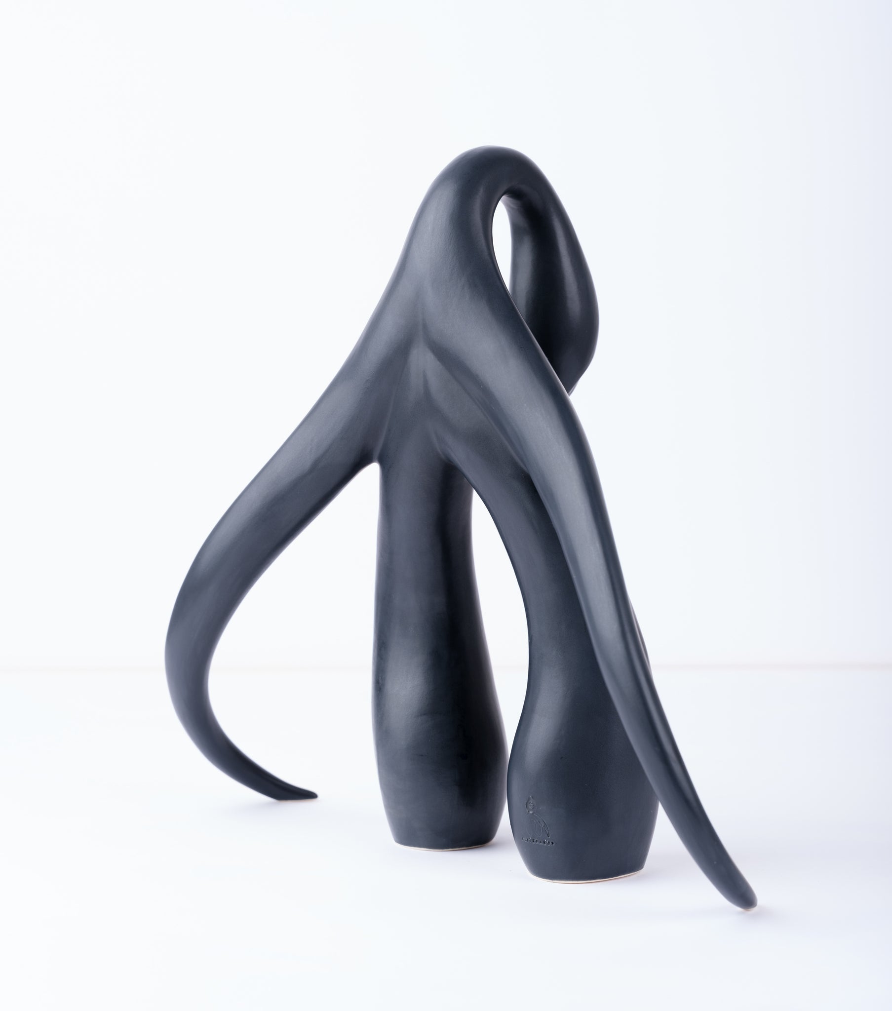 3/4 back view of "Swan Series" ceramic sculpture in matte black by Sophia Wallace, 2022.