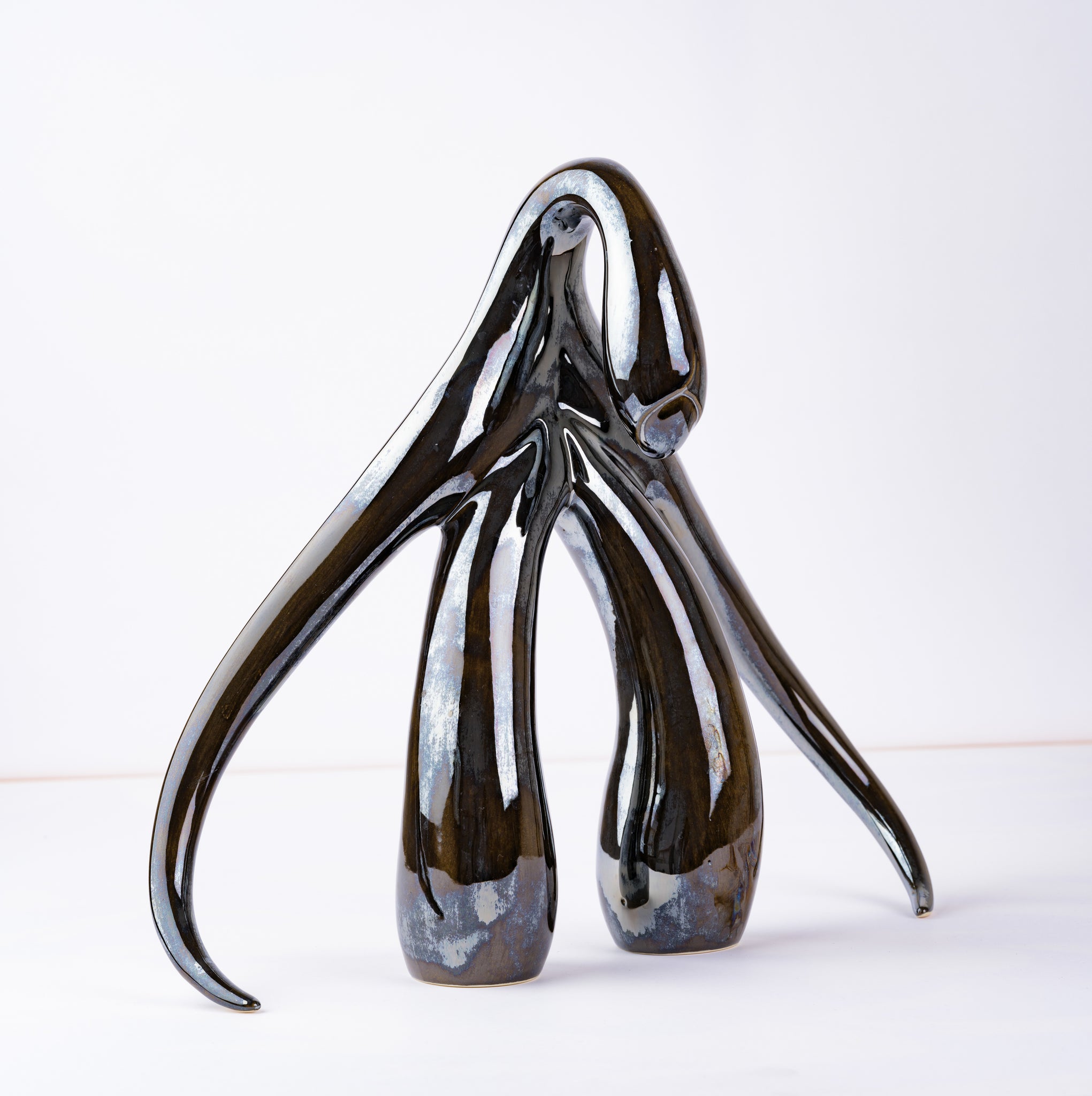 3/4 front view of "Swan Series" ceramic sculpture in black opal by Sophia Wallace, 2022.