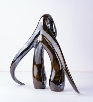 3/4 back view of "Swan Series" ceramic sculpture in black opal by Sophia Wallace, 2022.
