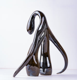 3/4 back view, low angle, of "Swan Series" ceramic sculpture in black opal by Sophia Wallace, 2022.