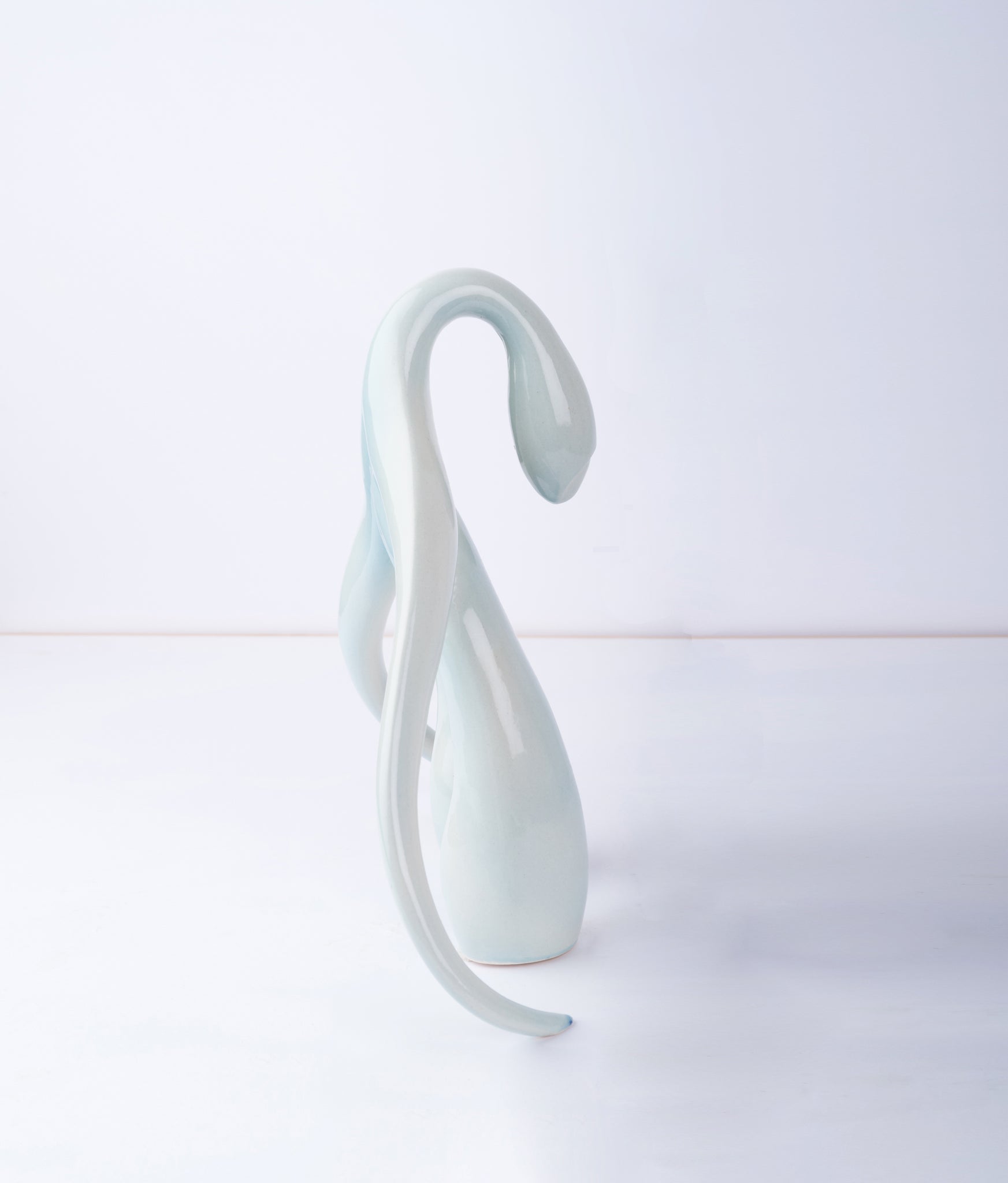 Side view of "Swan Series" ceramic sculpture in light aqua by Sophia Wallace, 2022.