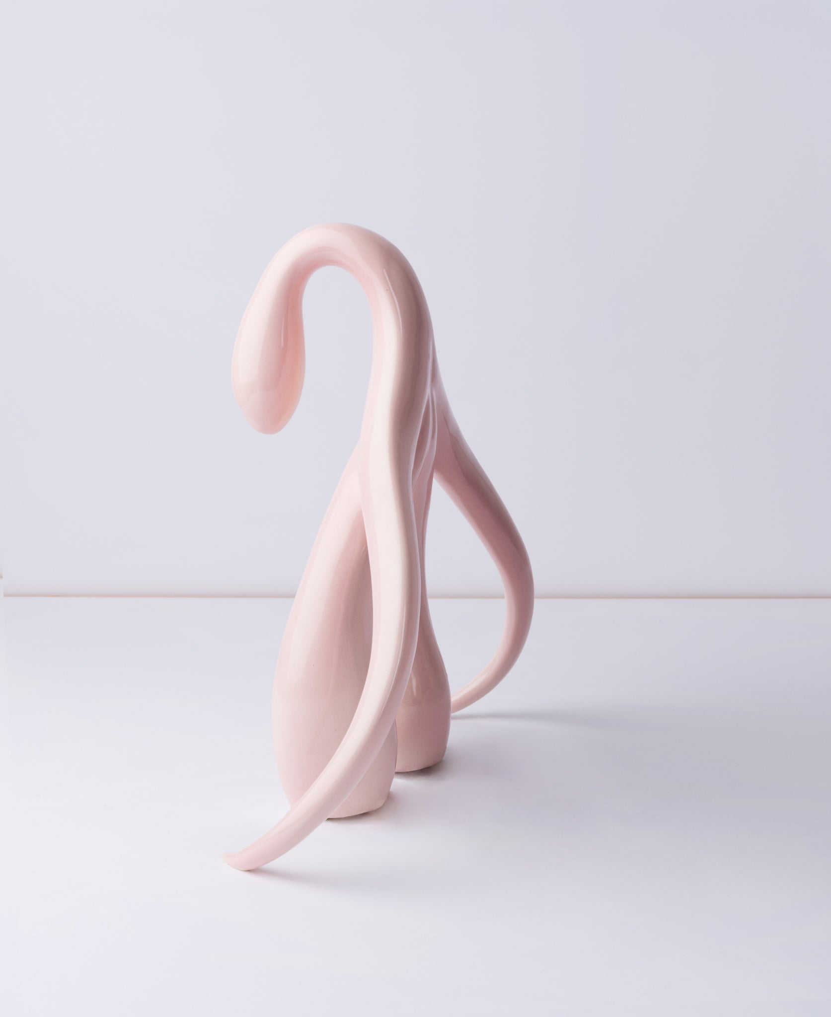Side view of "Swan Series" ceramic sculpture in light pink by Sophia Wallace, 2022.